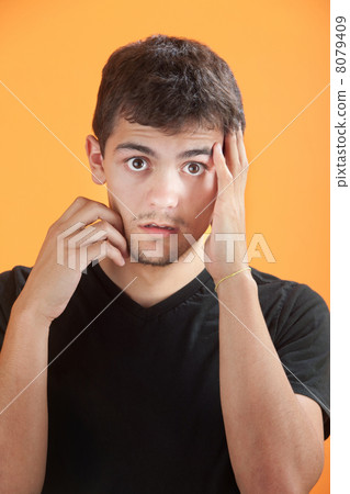 Young Man with Hand on Face 8079409