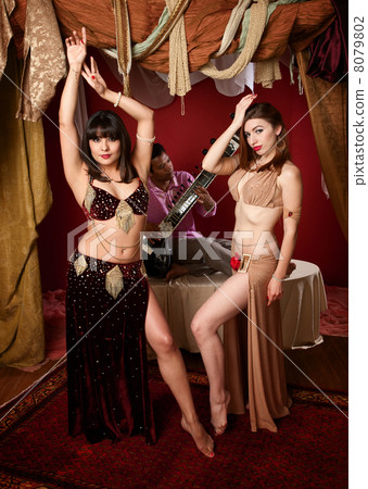 Beautiful Belly Dancers With Indian Man Playing a Sitar 8079802