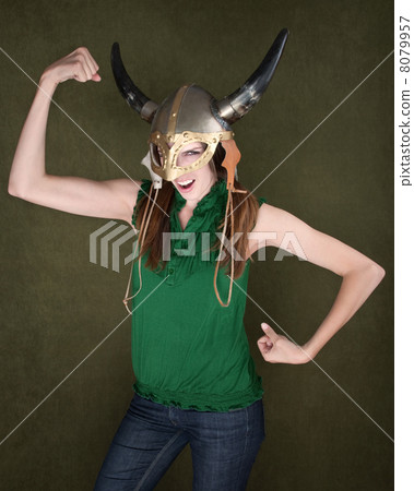 Woman in Viking Helmet Flexes Her Muscles 8079957