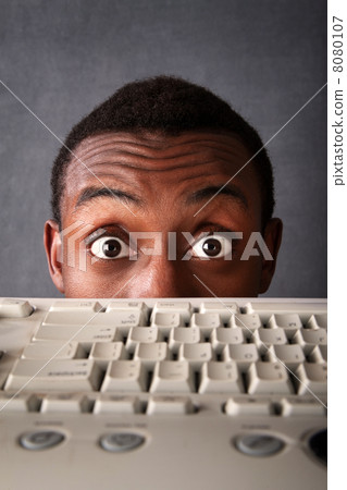 Surprised Eyes of Man Above Keyboard 8080107