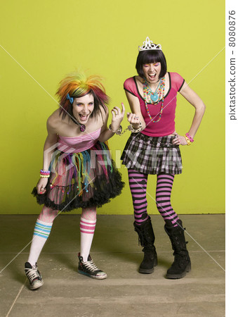 Young punk women linked by handcuffs 8080876