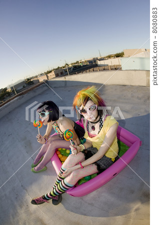 Girsl on a roof in a plastic pool 8080883
