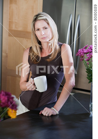 Woman with Mug in Kitchen 8080889