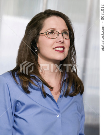 Businesswoman with a cell phone in her ear 8081012