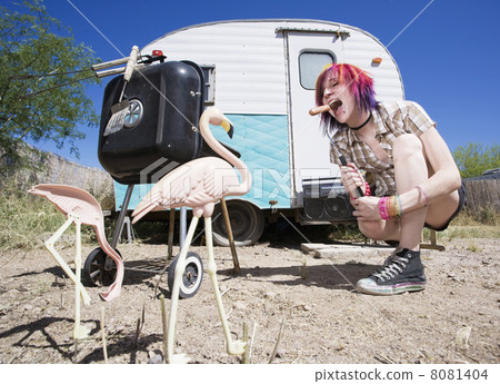 Girl in front of a trailer eating a hotdog Girl in front of a trailer eating a hotdog 8081404