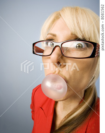 Woman in red blowing a bubble Woman in red blowing a bubble 8081562