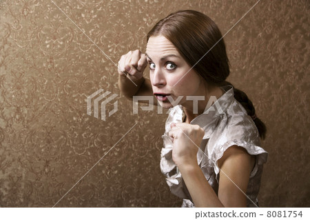 Young Woman Throwing a Punch 8081754