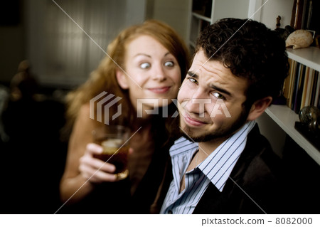 Woman Leers at Man at Party 8082000