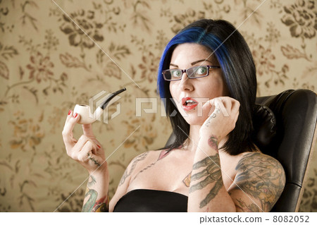 Pretty Woman with Tattoos in a Leather Chair Pretty Woman with Tattoos in a Leather Chair 8082052