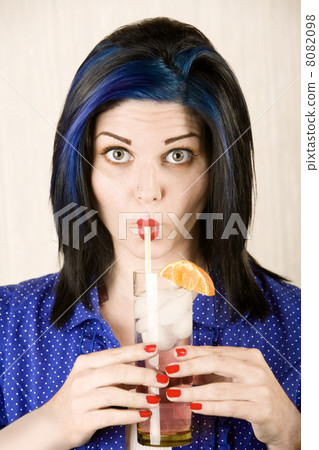 Pretty woman sipping a cocktail 8082098