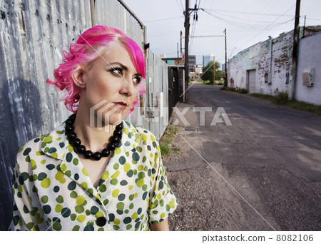 Woman with Pink Hair in an Alley 8082106