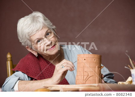 Woman working with clay Woman working with clay 8082348