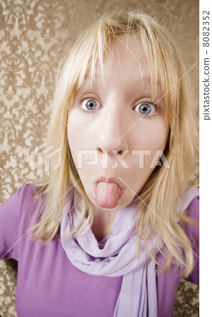 Young girl sticking out her tongue 8082352