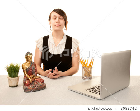 Woman meditating at her desk Woman meditating at her desk 8082742