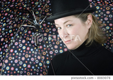 Woman in a bowler hat with umbrella Woman in a bowler hat with umbrella 8083078