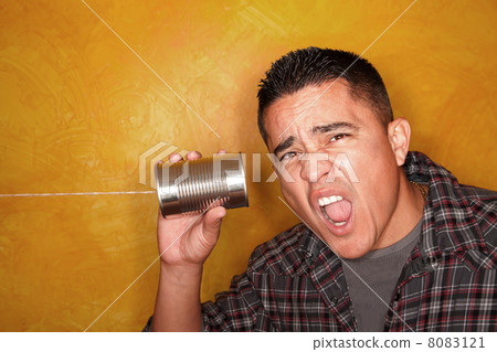 Hispanic man with tin can telephone 8083121