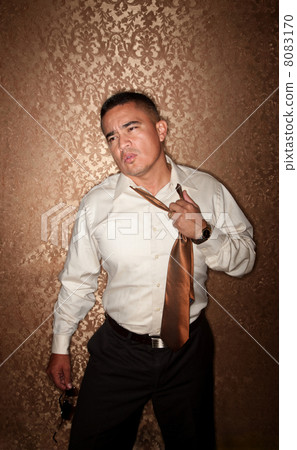 Hispanic Man Tugging at His Tie Hispanic Man Tugging at His Tie 8083170