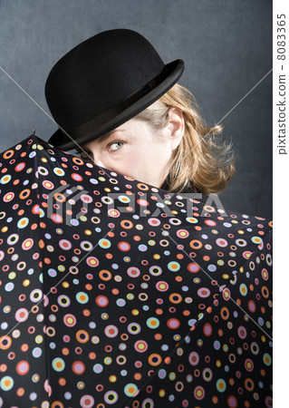 Woman in a bowler hat with umbrella 8083365