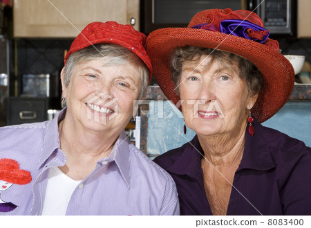 Two Senior Women Wearing Red Hats 8083400