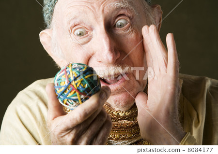 Man contemplating a rubber band ball Man contemplating a rubber band ball 8084177