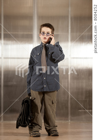 Little boy in adult clothes on cell phone Little boy in adult clothes on cell phone 8084252