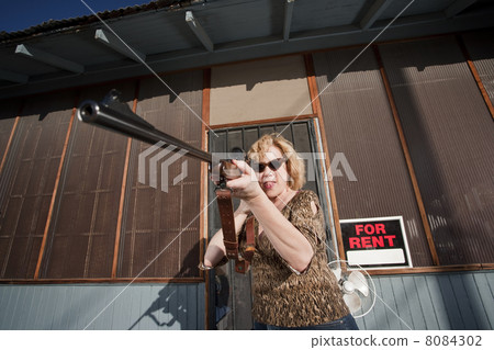 Woman on front porch with rifle Woman on front porch with rifle 8084302
