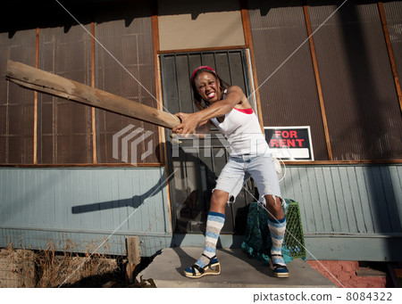 Woman swinging a board Woman swinging a board 8084322