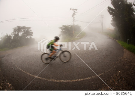 Bicyclist in the Costa Rican cloud forest 8085641