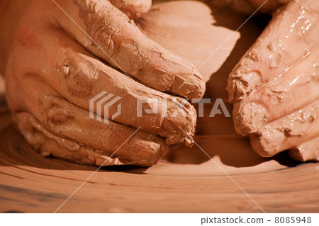 Hands forming clay 8085948