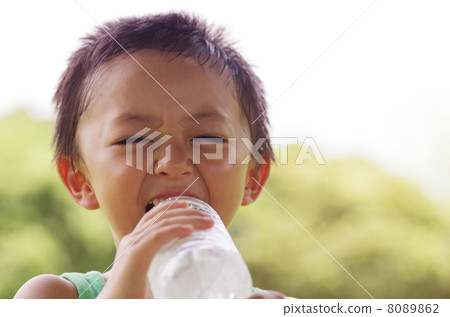 A child drinking water with a smile 8089862