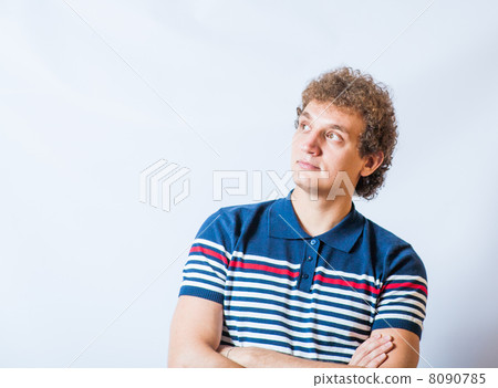 Young blonde adult caucasian man in casual clothes on a gray background. 8090785