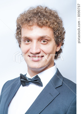 smiling curly man in black and bow tie smiling curly man in black and bow tie 8090787
