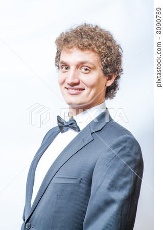 smiling curly man in black and bow tie smiling curly man in black and bow tie 8090789