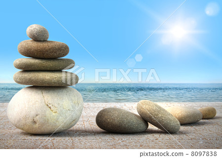 Stack of spa rocks on wood against blue sky Stack of spa rocks on wood against blue sky 8097838