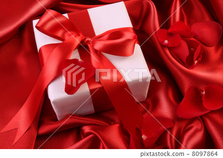 Red ribbon holiday gift on satin Red ribbon holiday gift on satin 8097864