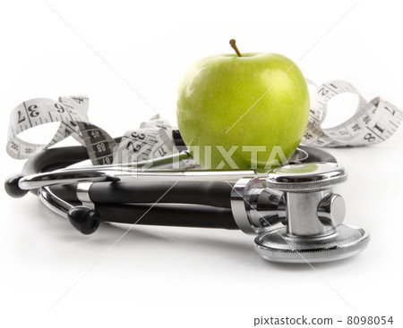 Green apple with stethoscope on white 8098054