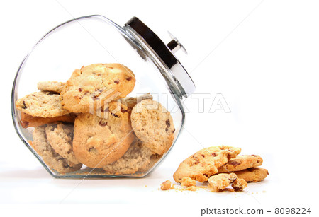Glass jar with cookies against a white Glass jar with cookies against a white 8098224