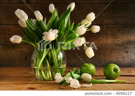White tulips in glass vase on rustic wood White tulips in glass vase on rustic wood 8098227