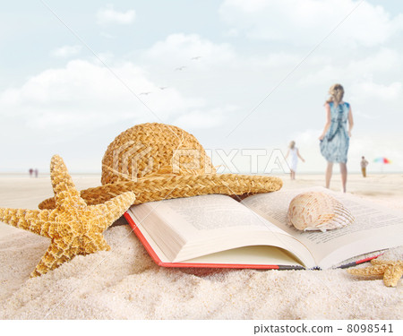 Straw hat , book and seashells in the sand 8098541