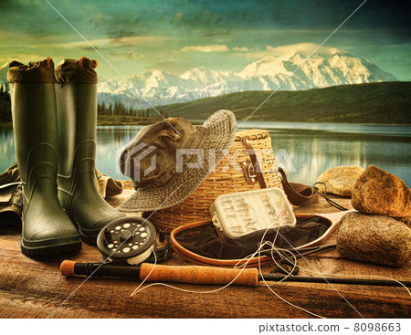 Fly fishing equipment on deck with view of a lake and mountains 8098663