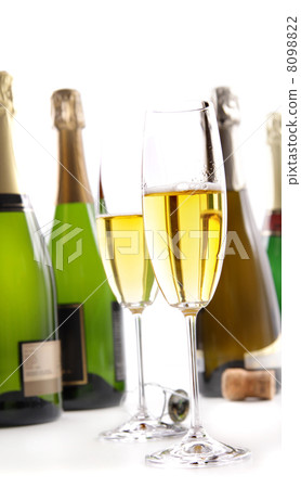 Glasses of champagne with bottles on white 8098822