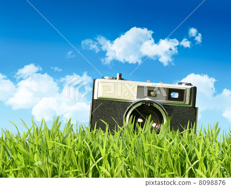 Vintage camera in tall grass Vintage camera in tall grass 8098876