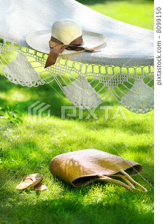Straw hat with brown ribbon laying hammock 8099150