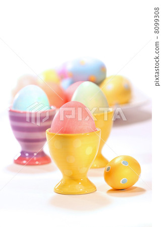 Egg cups with colored eggs on white Egg cups with colored eggs on white 8099308