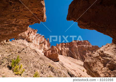 Rock formations at Charyn canyon under blue sky Rock formations at Charyn canyon under blue sky 8101098