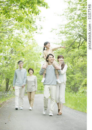 Three generation family walking in fresh green 8107546