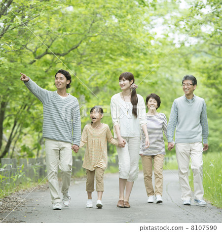 Three generations families holding hands in fresh green 8107590