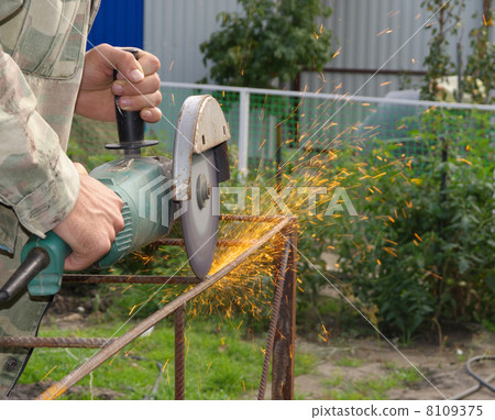 Angle Grinder Metal sawing with flashing sparks  handheld electric instrument 8109375