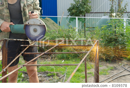 Angle Grinder Metal sawing with flashing sparks handheld electric instrument Angle Grinder Metal sawing with flashing sparks handheld electric instrument 8109378