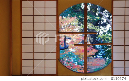 Autumn leaves through the round window Autumn leaves through the round window 8110374